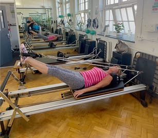 Zoe Applied Pilates Feet in Straps Reformer