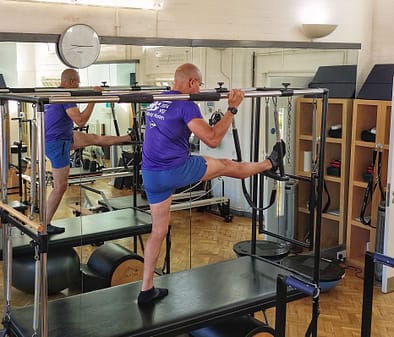 Teejay Applied Pilates Hamstring stretches Cadillac Teejay on Cadillac doing Hamstring Stretch