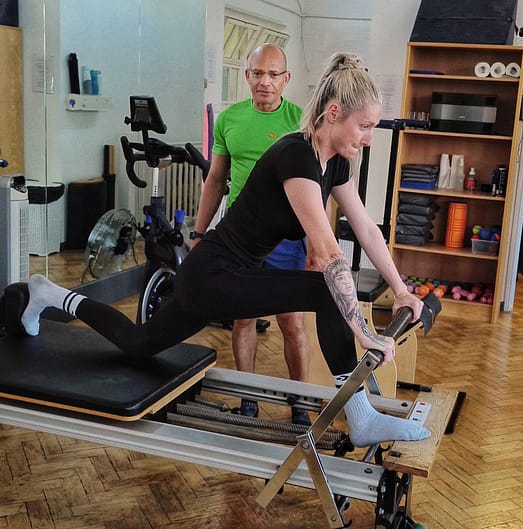 Pilates Teching Thigh Stretches on a Reformer Pilates St Albans